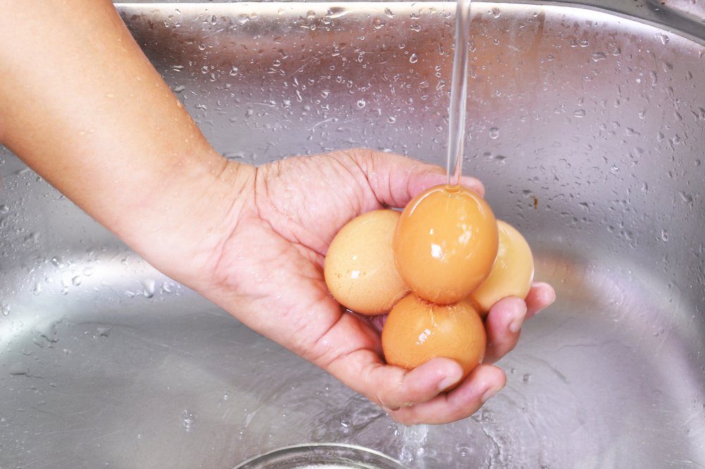 Men Hands Washing Eggs At The Sink