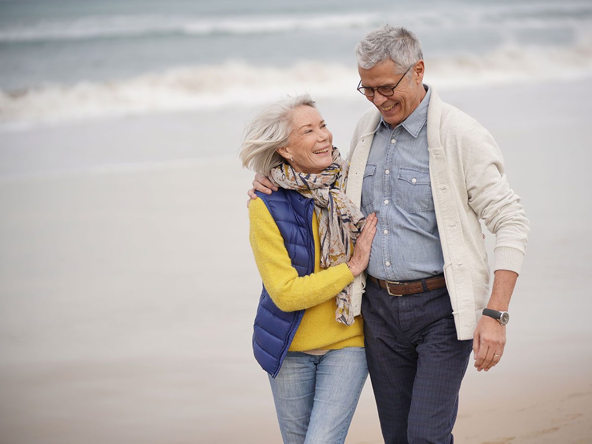 Walking 10,000 steps a day - senior couple at beach