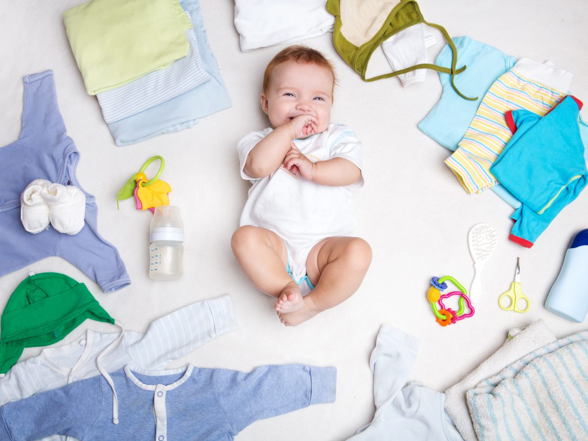 Cute baby posing with baby clothes