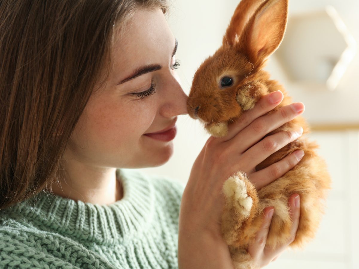 Young woman with pet bunny